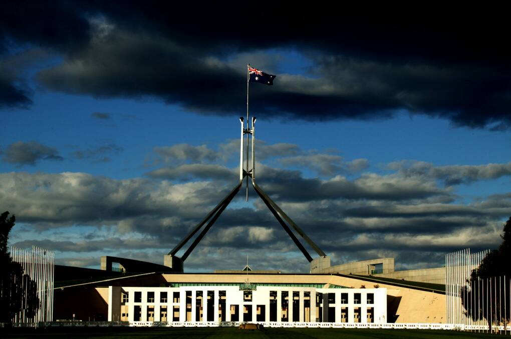 The Australian flag atop Parliament House in Canberra. Debate over whether the date of Australia Day should be changed has divided the nation.  Photo: Rob Homer