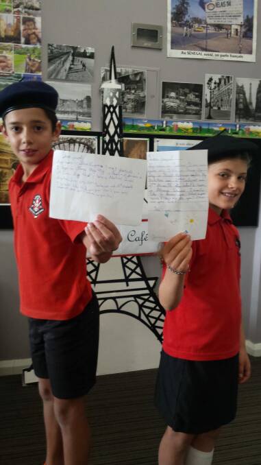 Aranda Primary School year 4 students Theodore Manikis, 10, and Annika Connelly-Hansen, 9, are keeping in touch with French pen pals using the old fashioned method. Photo: Supplied