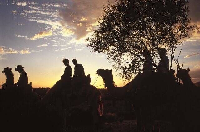 Camel rides are a novel way to view Uluru.  Photo: Voyages Indigenous Tourism Australia