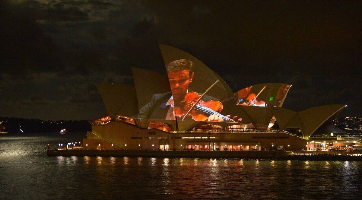 Andrew Haveron fiddling about on sails of the Sydney Opera House. Photo: CSO