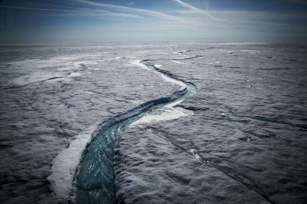 Meltwater flows along a supraglacial river on the Greenland ice sheet, one of the Earth's biggest and fastest-melting chunks. Photo: Josh Haner