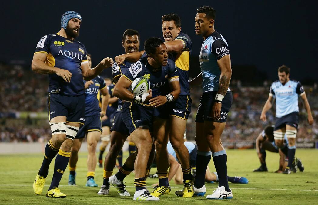 The Brumbies celebrate Christian Lealiifano's opening try against the Waratahs. Photo: Getty Images