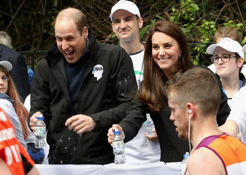 Prince William, Duke of Cambridge is sprayed with water during the London Marathon. Photo: Chris Jackson