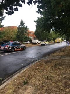 Police have evacuated a block of units in Red Hill after a man barricaded himself inside an apartment. Photo: Jamila Toderas