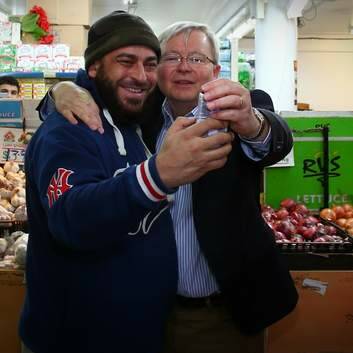 One more for good luck: Kevin Rudd socialises at the Flemington Fruit Market. Photo: Andrew Meares