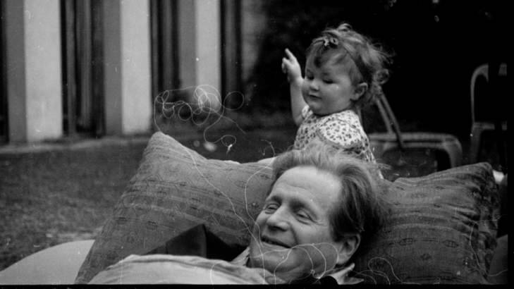 An intriguing photo of a very relaxed Walter Burley Griffin with an unknown child that was taken at Castlecrag in the 1920s. Photo: Supplied by the National Library