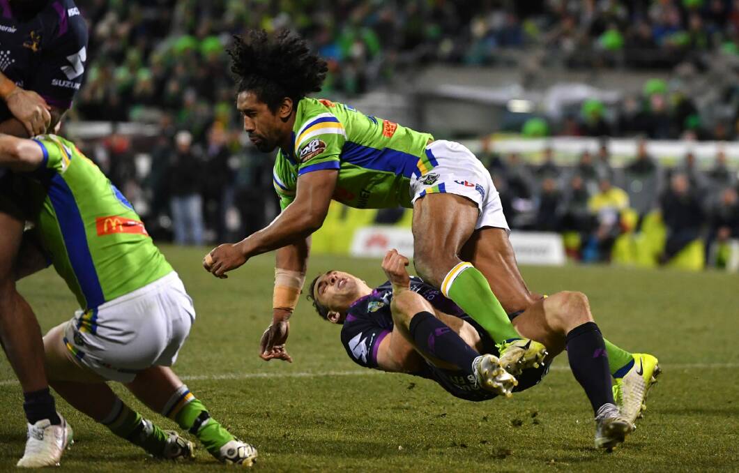Billy Slater goes to ground after being collected high by Sia Soliola. Photo: Getty Images