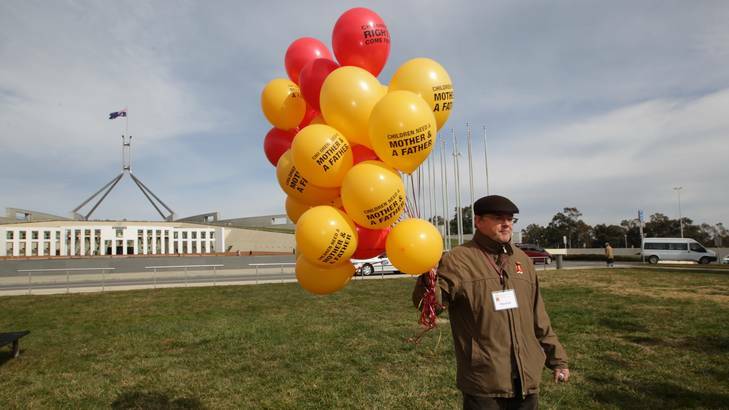 People gather for the National Marriage Day Rally with the message "Husband and Wife Equals Life" on the front lawn of Parliament House in Canberra on Tuesday. Photo: Alex Ellinghausen