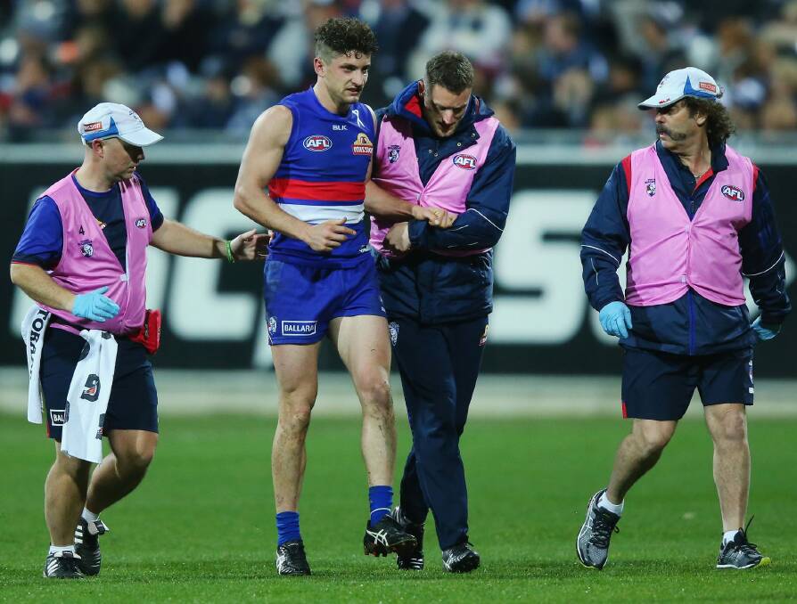 Bulldog Tom Liberatore hobbles off with injury. Photo: Getty Images