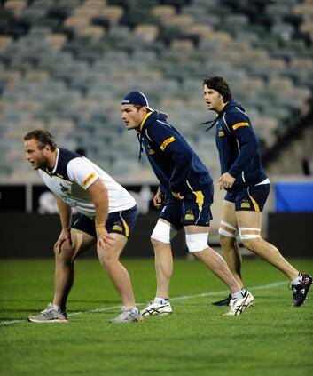 Ben Mowen, centre, leads Brumbies players during the Captain's Run at Canberra Stadium on Friday. Photo: Graham Tidy