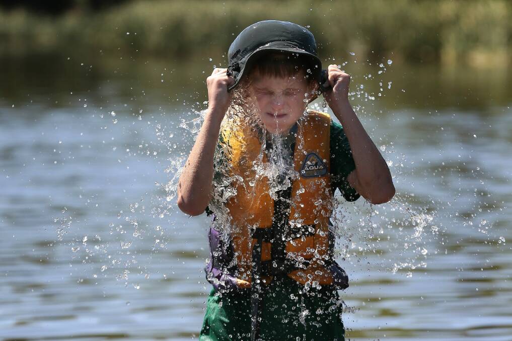 Chapman's Dylan Kirsten, 11, cools off in Lake Burley Griffin. Photo: Jeffrey Chan