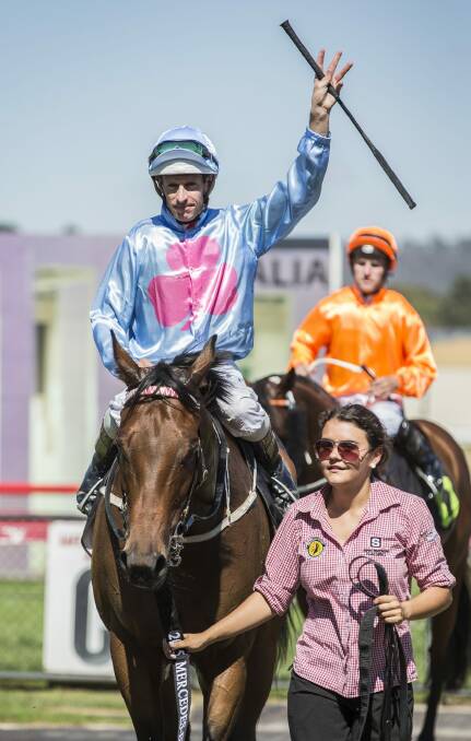 Jockey Hugh Bowman on Snippets Land acknowledges the crowd after winning the Canberra National Sprint. Photo: Matt Bedford