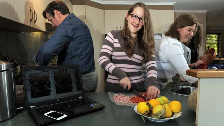 A TIME AND A PLACE: Georgie Sanderson, centre, helps out in the kitchen with her parents Grant and Jenny and friend Antonia Skene. Photo: Graham Tidy