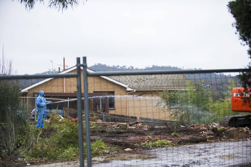 Gone: Workers demolish a Mr Fluffy home in Farrer. Photo: Rohan Thomson