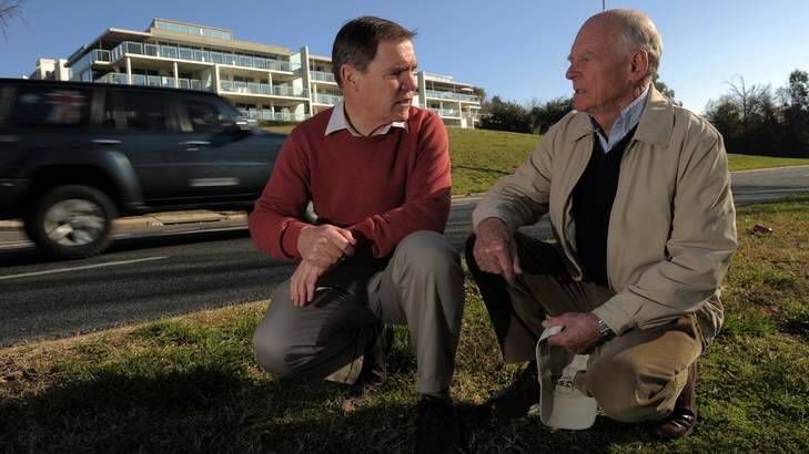 Landmark Apartments residents Ian Pearson and Graham Neil check out the traffic noise on Bowen Drive. Photo: Graham Tidy