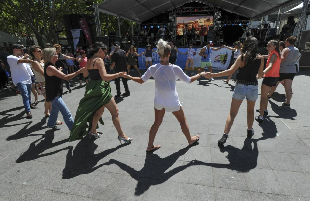 People get into the swing of the festival with Greek dancing in front of the Greek Glendi stage in Garema Place.
 Photo: Graham Tidy