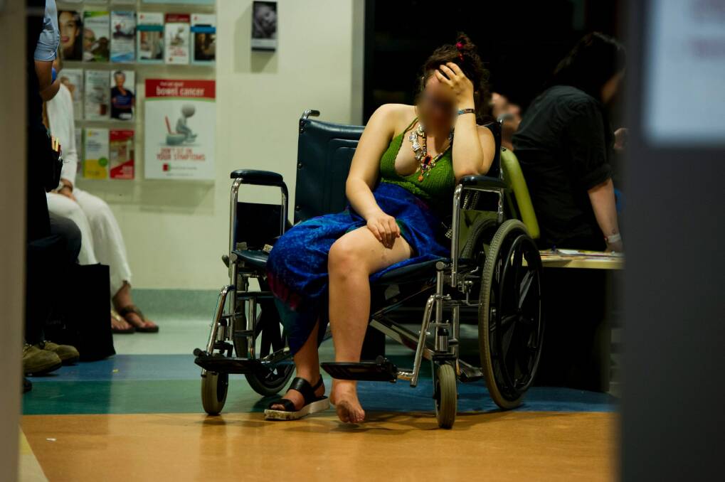 Intoxicated woman waits for treatment  in the waiting room of the emergency department at Calvary Hospital on her ankle after falling off her bicycle Photo: Jay Cronan