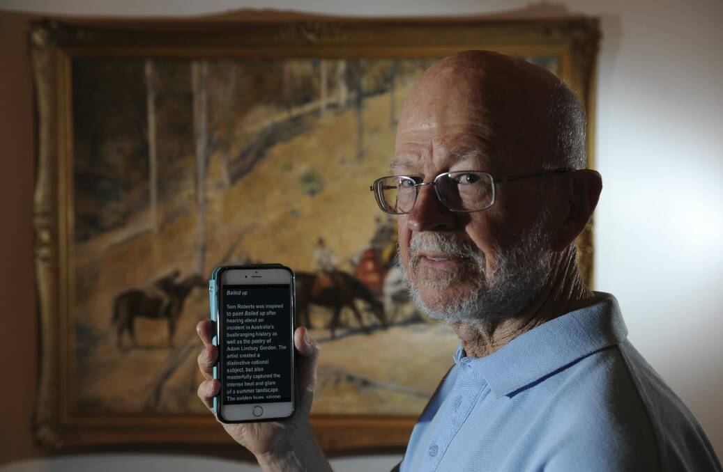 Haydn Daw using the Open Access Tour app to read captioning for the NGA's Tom Roberts' audio tour. Photo: Graham Tidy