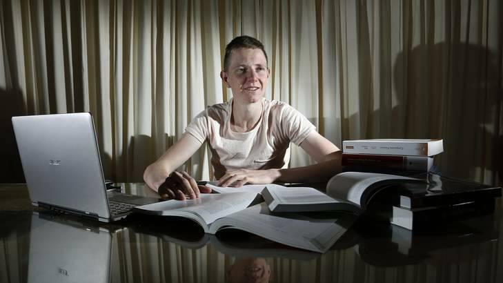 ANU Bachelor of Commerce student Adam West studying at home in Calwell for the first week of his exams. Photo: Jeffrey Chan