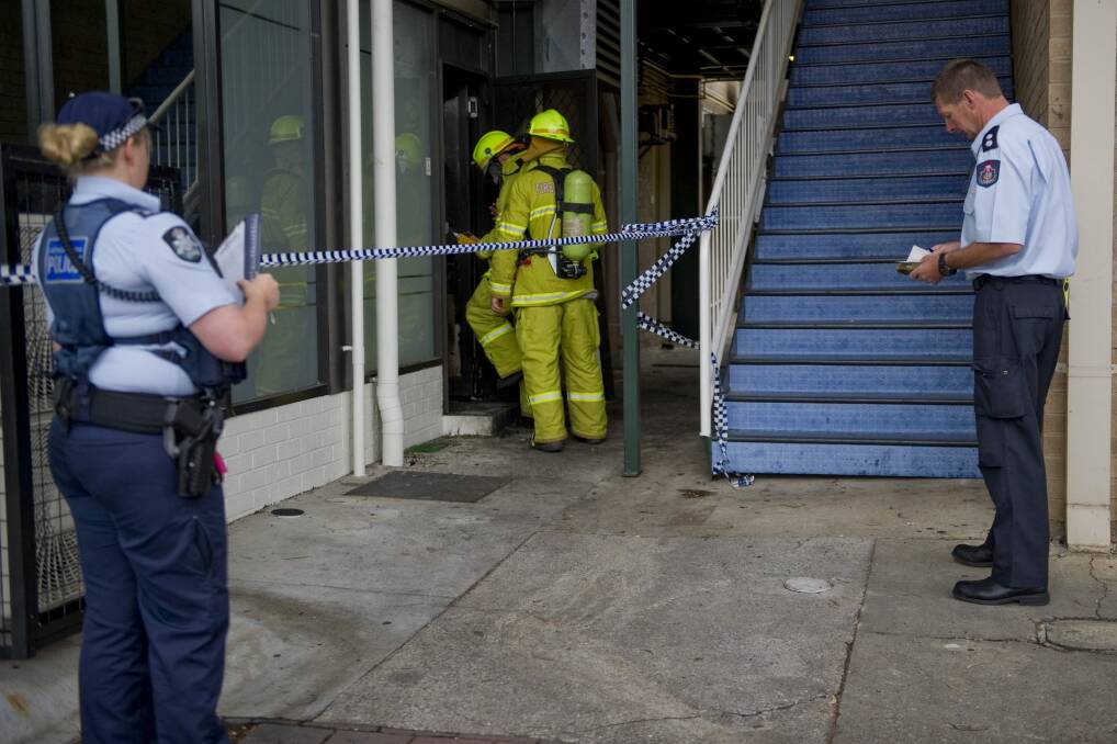Fire crews and police investigate the alleged arson at the Brierly Street cafe in Weston in March 2014. Photo: Jay Cronan