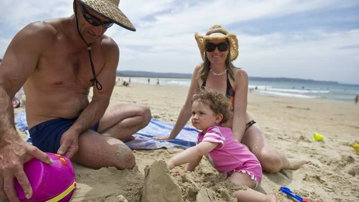 Sunny summer times in Tathra being enjoyed by holiday makers Anthony Moore, daughter Holly Moore 13 months and mother Jo Stuart. Photo: Jay Cronan