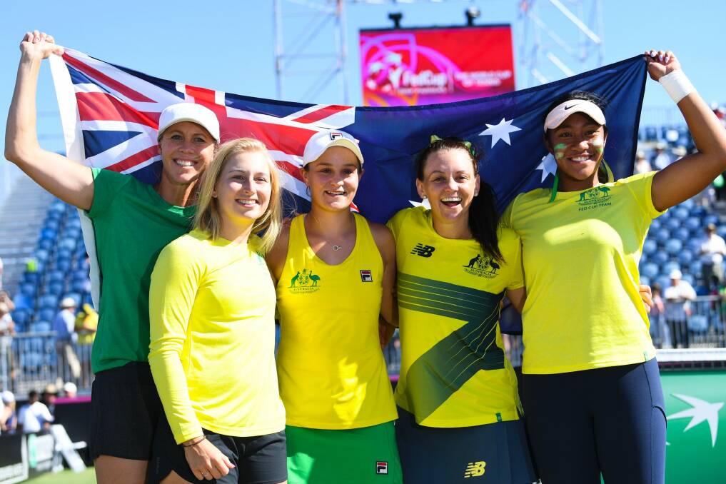 Australian Fed Cup team captain Alicia Molik, Daria Gavrilova, Ashleigh Barty, Casey Dellacqua and Destinee Aiava celebrate Australia's win over Ukraine at the Canberra Tennis Centre. Photo: AAP