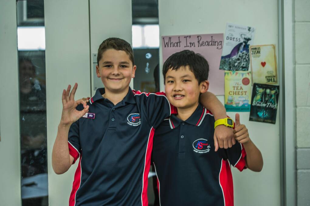 Amaroo School student Ross Kelly (left), who learnt sign language to talk with deaf friend Isam Gurung. Photo: Karleen Minney