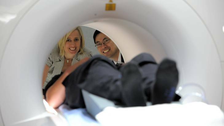 ACT Health Minister Katy Gallagher is given a demonstration of the new MRI equipment by Dr Raymond Kuan, Chairman of the Canberra Imaging Group, with patient Nicholas Jones. Photo: Graham Tidy