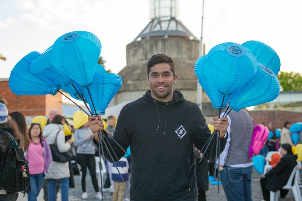 Jarrad Butler Carries 2 fists full of the Blue Lanterns friends family and the 1000s of supporters at the Canberra Leukaemia Foundation Light the Night walk to help more Australians beat blood cancer through research and support Photo Jay Cronan Photo: Jay Cronan
