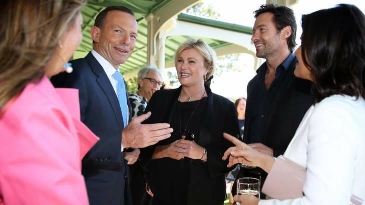 Prime Minister Tony Abbott with actors Deborah-Lee Furness and Hugh Jackman after announcing his support for making overseas adoption easier for Australian couples. An expert advisory group on adoptions was recently disbanded by the government. Photo: Jane Dempster