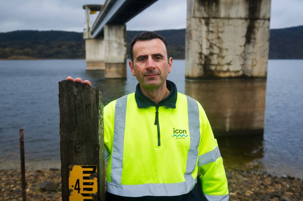 Water industry operator Rob Tonna stands where the Googong Dam water level used to be.  Photo: Dion Georgopoulos