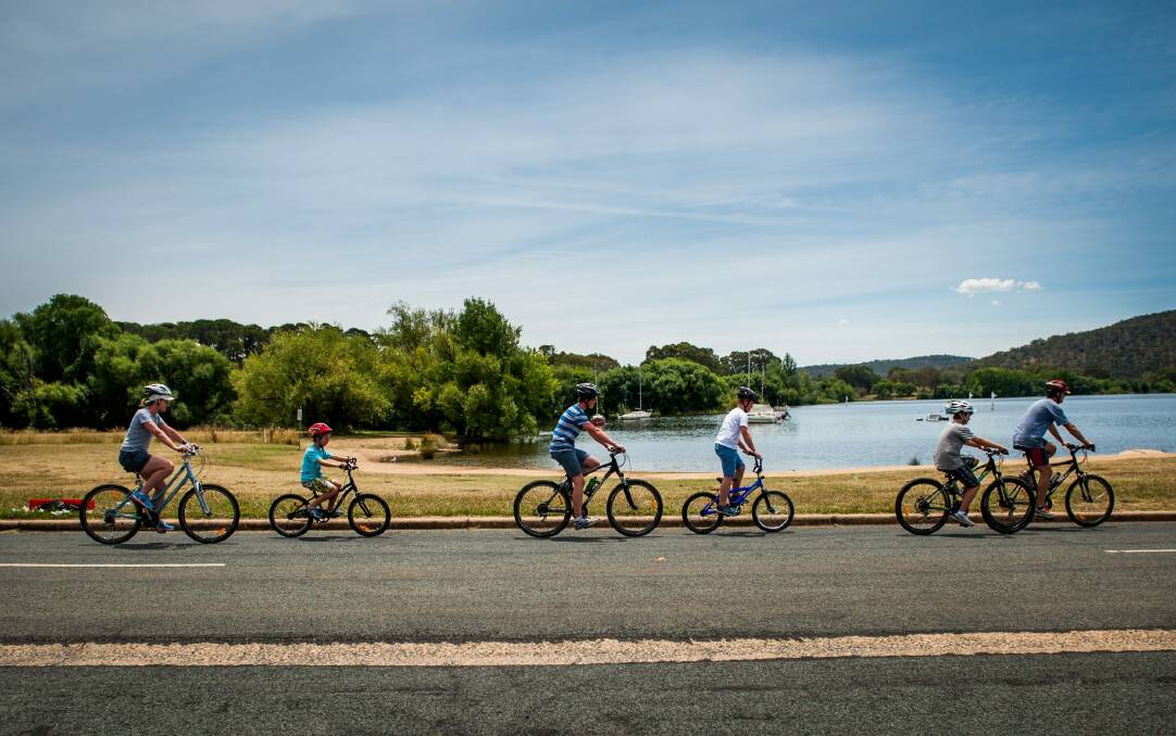 The Chipman family get some New Year's Day bike riding in at Yarralumla Bay before the wet weather arrives. Photo: Elesa Kurtz