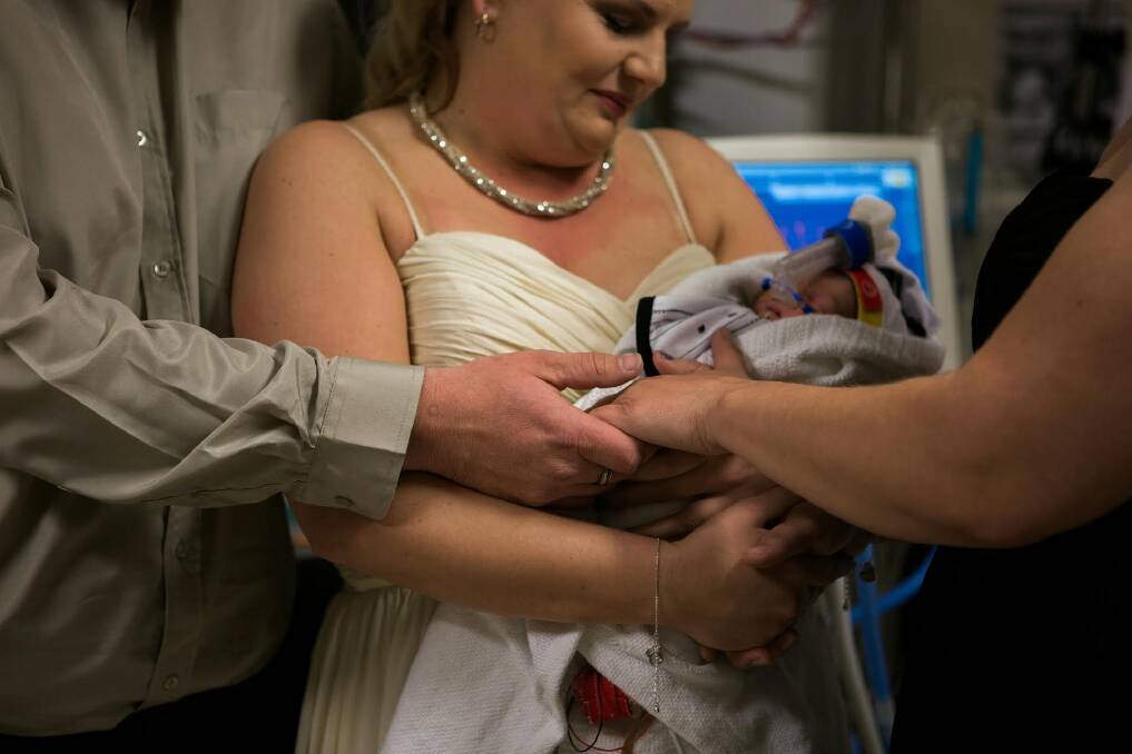 James and Kylie Wiggins with their son Dolton during their wedding ceremony  the Neonatal Intensive Care Unit at the Canberra Hospital. Photo: Genevieve Dahl Photography
