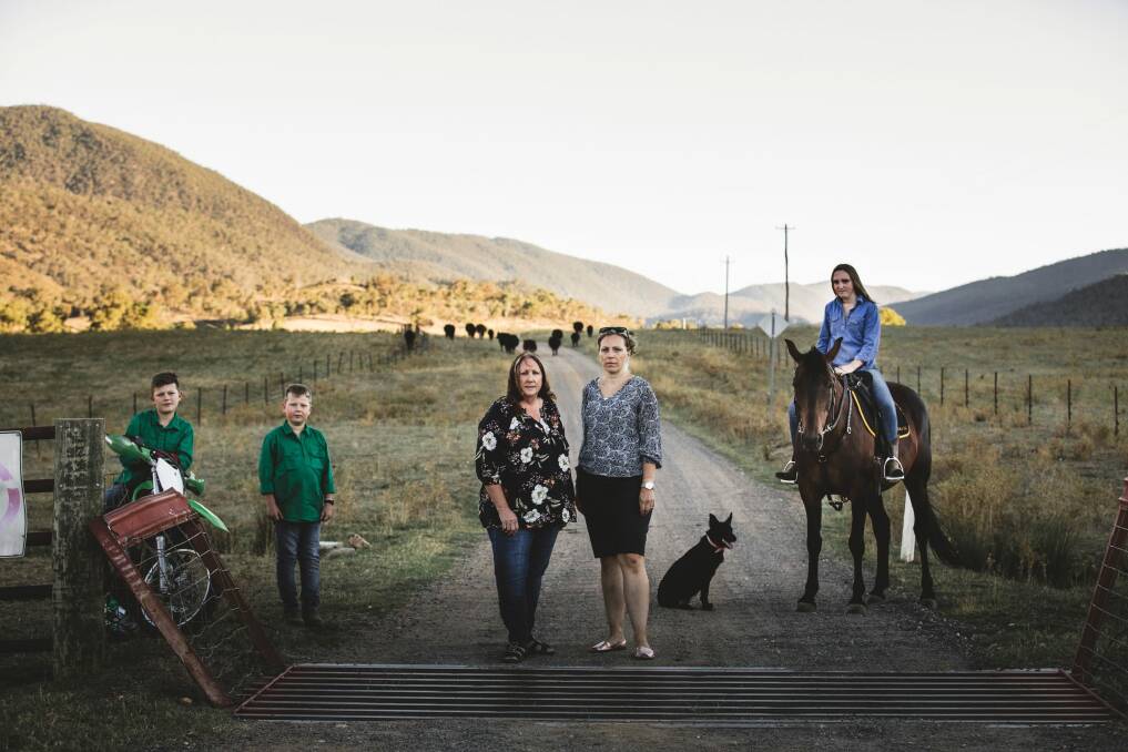 Mandy Curtis (left) and Natalie Hogan (right), neighbours of Caloola Farm, with Natalie's sons Isaac, 11, and Lewis, 8, and Mandy's daughter, Tori.  Photo: Jamila Toderas