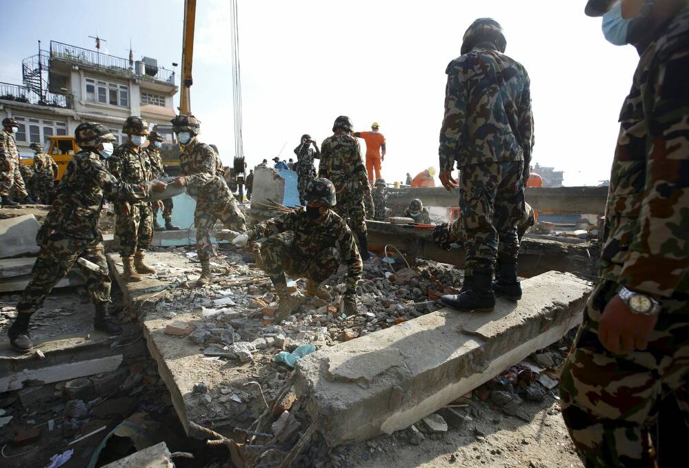 Soldiers from the Nepalese army clear debris from a collapsed house while searching for victims in Kathmandu. Photo: Reuters