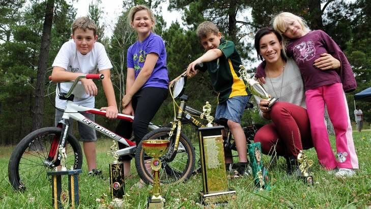 BMX champion Caroline Buchanan, second from right, spent time at Fadden Pines to present end of year trophies to members of the Tuggeranong Vikings BMX Club on Saturday. From left: Andrew Beer, Natalie Pettett, Jeremy Pettett and Samantha MacArthur. Photo: Graham Tidy