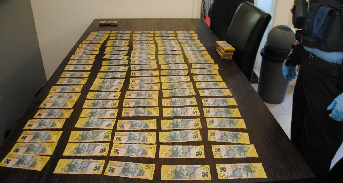 Police say they seized $42,000 from the Chisholm house. Photo: ACT Policing