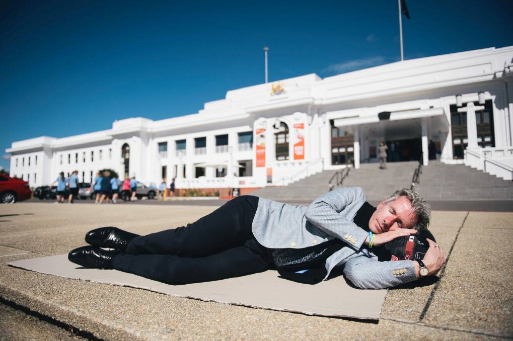 Chief Executive of Menslink Martin Fisk trials a cardboard bed ahead of the Vinnies CEO Sleepout. Photo: Rohan Thomson
