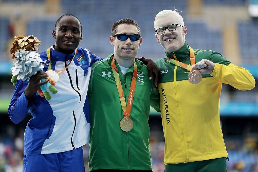 Chad Perris, right, with his bronze medal in Rio along with silver medalist Johannes Nambala of Namibia and gold medalist Jason Smyth of Ireland. Photo: Getty Images