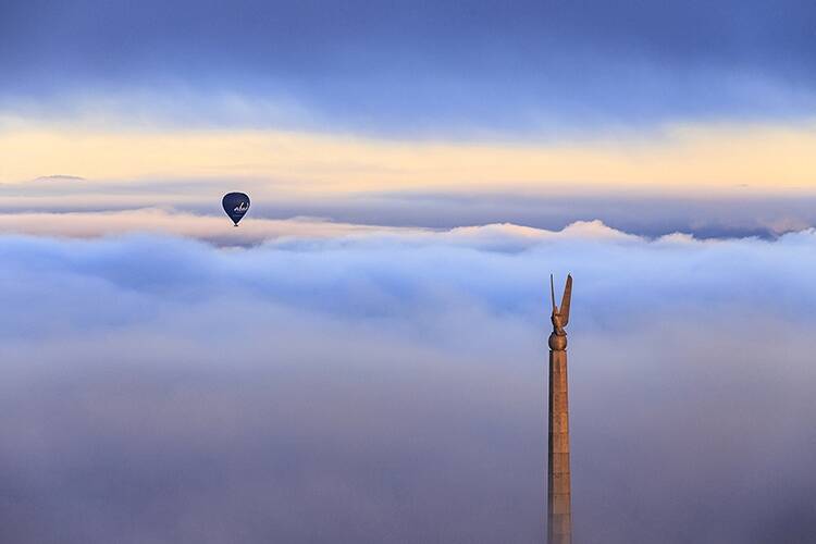 Chad Clarke's winning photo "Soaring over eagles" capturing one of the city's iconic autumn balloons and our American 'Eagle' peeking through the cloudy skies. Photo: Chad Clarke
