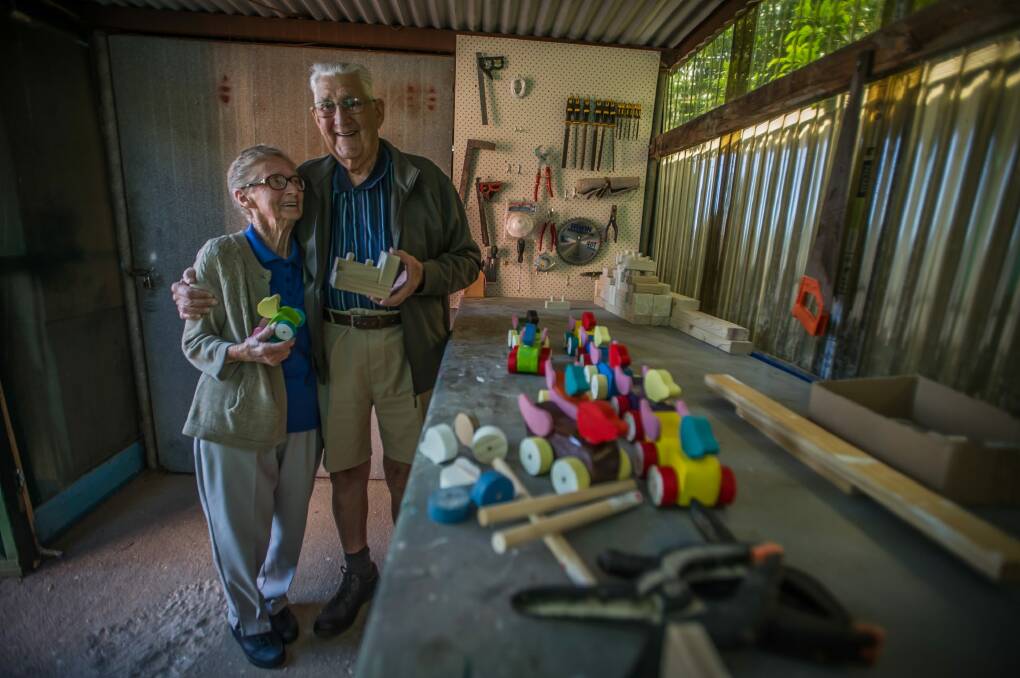 Kambah couple Beryl and John Fillery build and paint wooden toys to give away to children. Photo: Karleen Minney