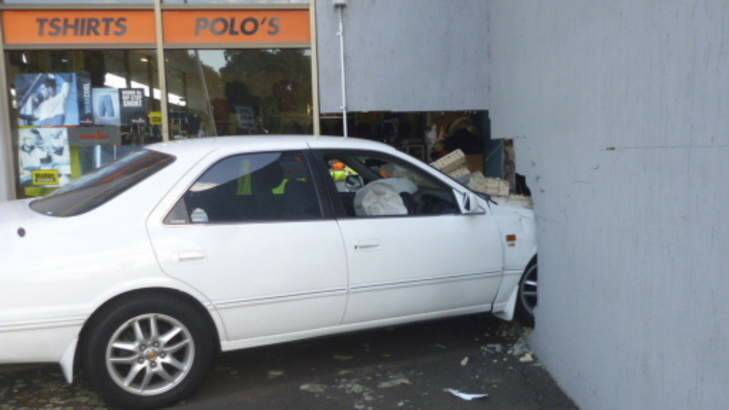 A car smashed into the "Action Sports Wear" shop front wall early Saturday. Photo: Katherine Griffiths