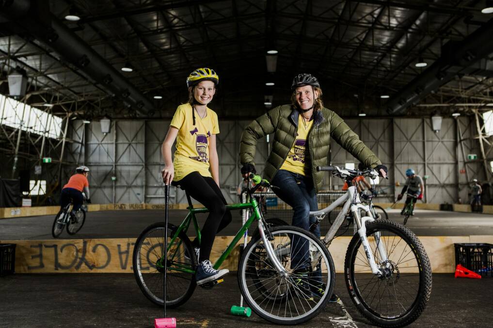 Ella Cuthbert, 13, and her mother Tara Sutherland, both of Watson, at the Canberra Bike Polo Tournament.  Photo: Jamila Toderas