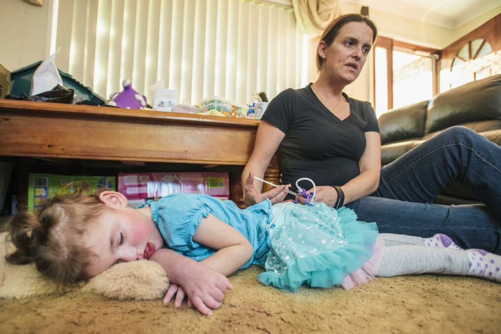 Cherie Dell gives her 3-year-old daughter Abbey a dose of cannabis oil to treat the seizures caused by a rare genetic disorder, CDKL5. Photo: Rohan Thomson