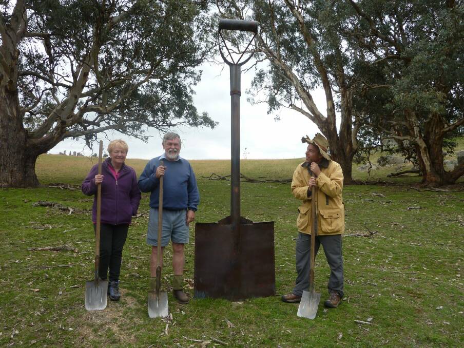 Tim joins Liz and John Baker at Giant Spade by Rosalind Lemoh,  in their sculpture paddock. Photo: Tim the Yowie Man