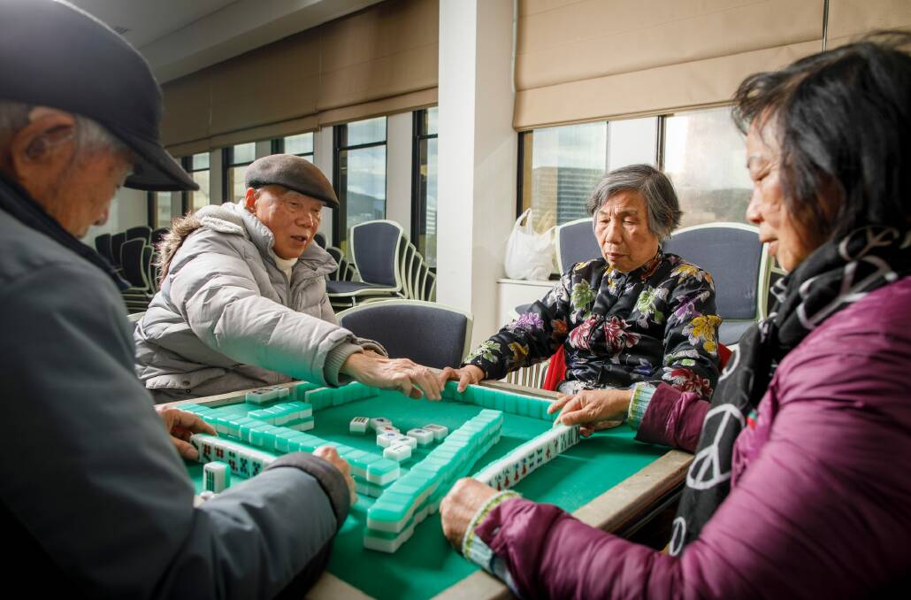 ACT Chinese Australian Association members Baoan Yuan, Shu Guichen, Cai Jiefeng, and Younei Peng play mahjong at the Theo Notaras Multicultural Centre. Photo: Sitthixay Ditthavong