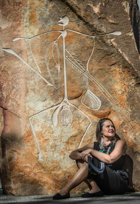  Canberra woman, Mikaela Jade, pictured with the Bill Nadji artwork at Reconciliation Place has been recognised for her working using technology to bring alive ancient Aboriginal stories. Photo: karleen minney