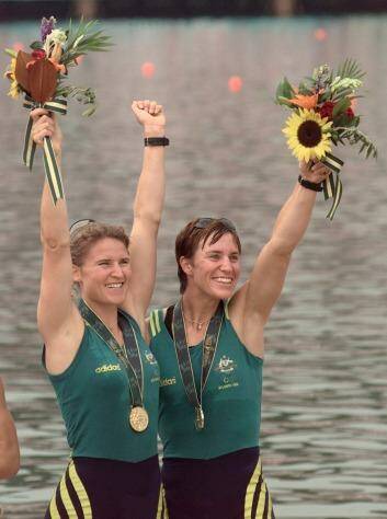 Australia's Gold medalists Megan Still (L) and Kate Slatter (R) in the women coxless pairs celebrate during the medals ceremony, July 27.  USA won the Silver and France the Bronze in the event.