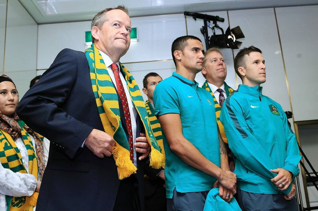 Socceroos Tim Cahill and Matt McKay with Bill Shorten during a visit to Parliament House on Monday. Photo: Stefan Postles