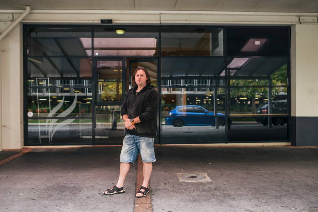 Woden Valley Community Council president Martin Miller outside the old Calibre cafe in Woden which recently closed after years of operation.
 Photo: Rohan Thomson